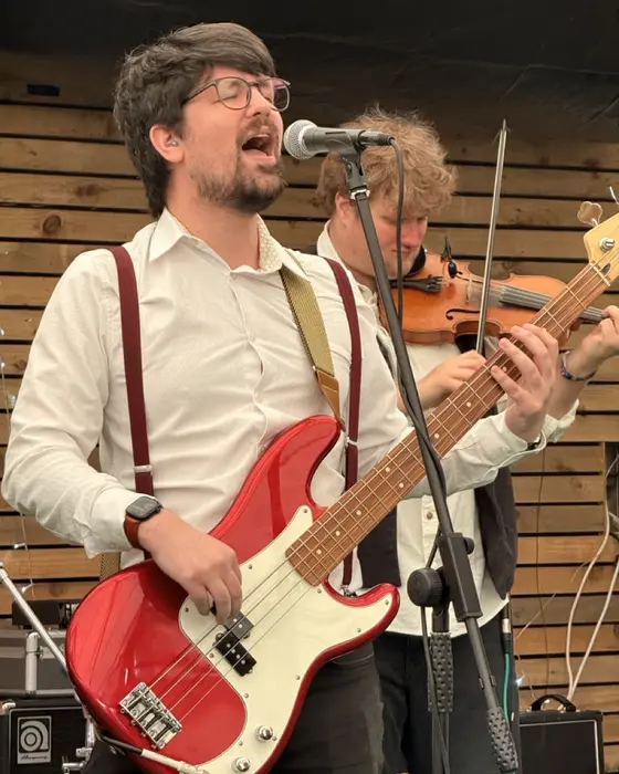 Jamie singing on bass, with the fiddle behind him